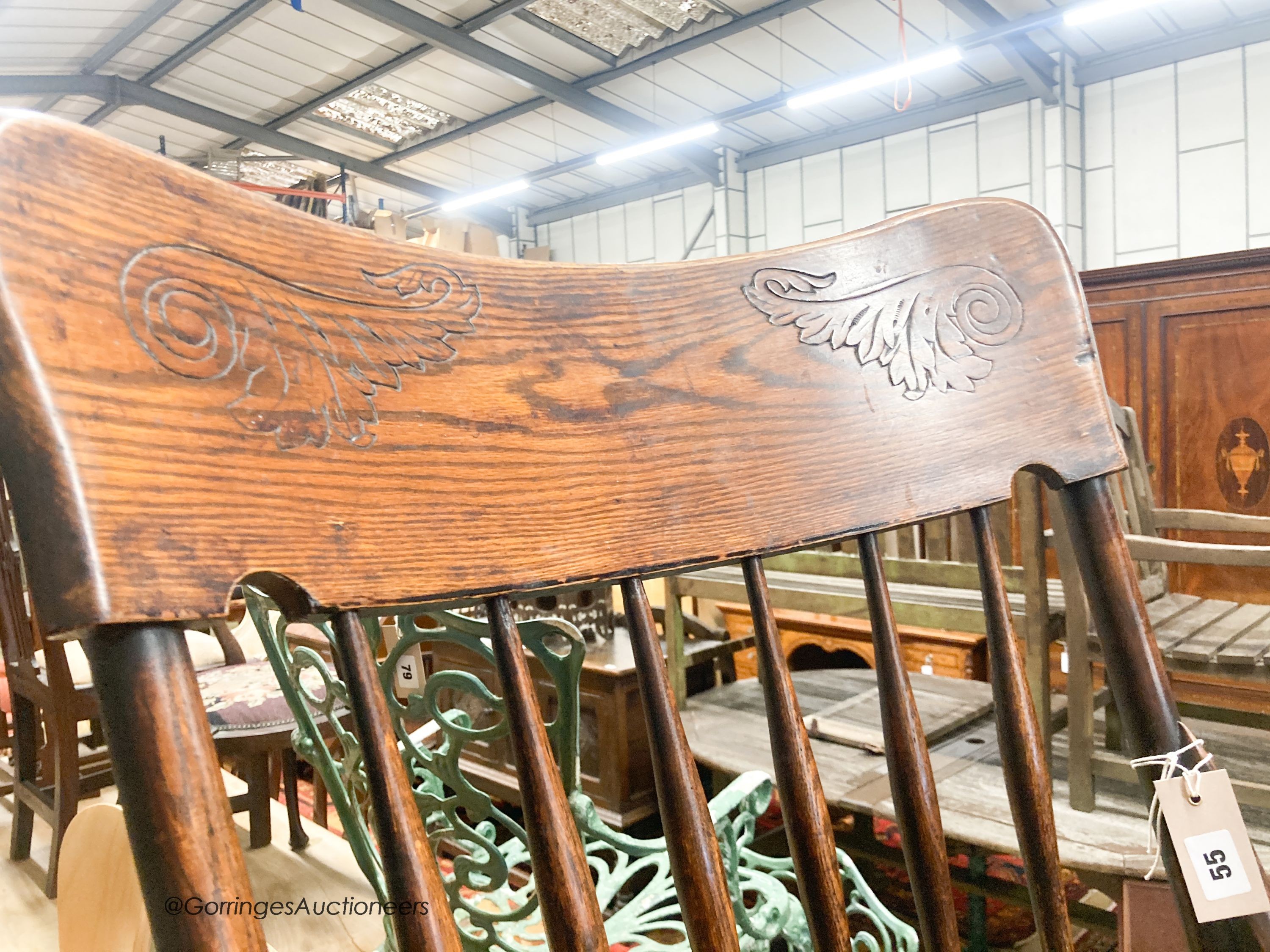 A late Victorian ash and elm comb back elbow chair